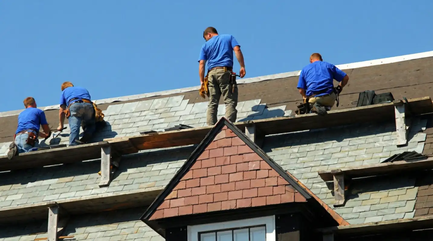 Roof replacement in progress with a team of professional contractors installing new shingles on a residential home in Riverside, CA