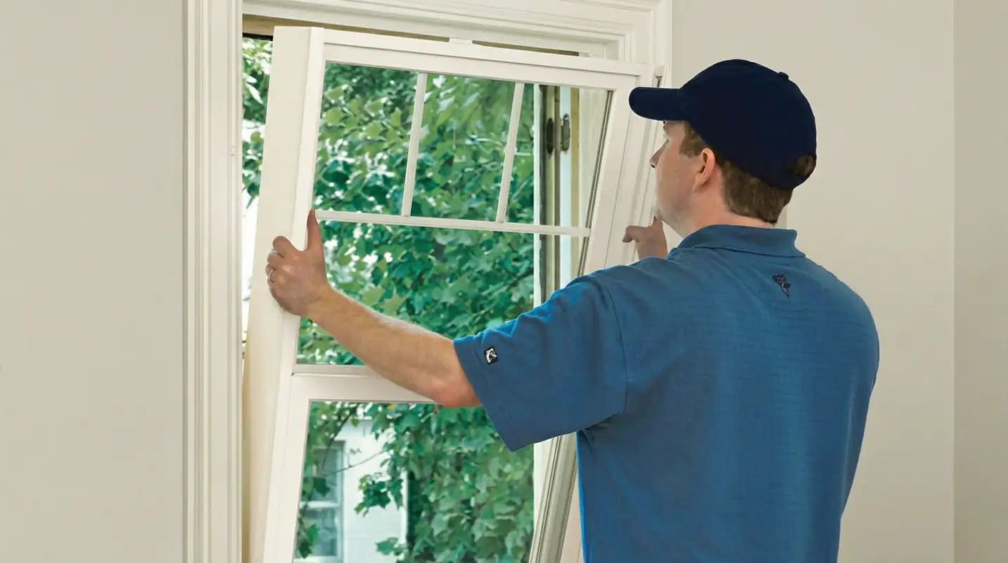 Professional contractors performing a residential window insulation and replacement service in Riverside, CA